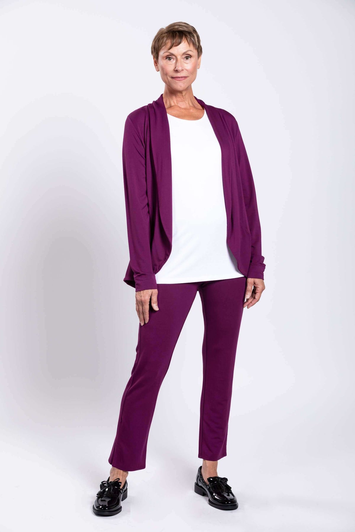 Front view of woman wearing Sarina Pant in plum bamboo with white top