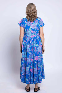 Back view of the Sharpie Dress with tiered skirt and vibrant floral pattern