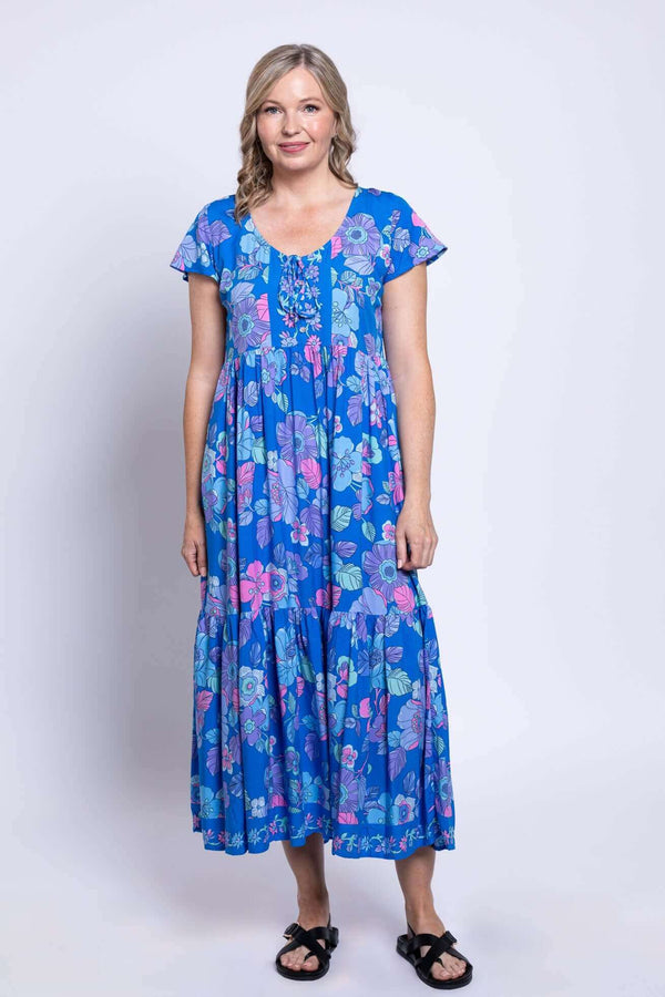 Front view of a woman wearing a blue floral tiered maxi dress with short flutter sleeves