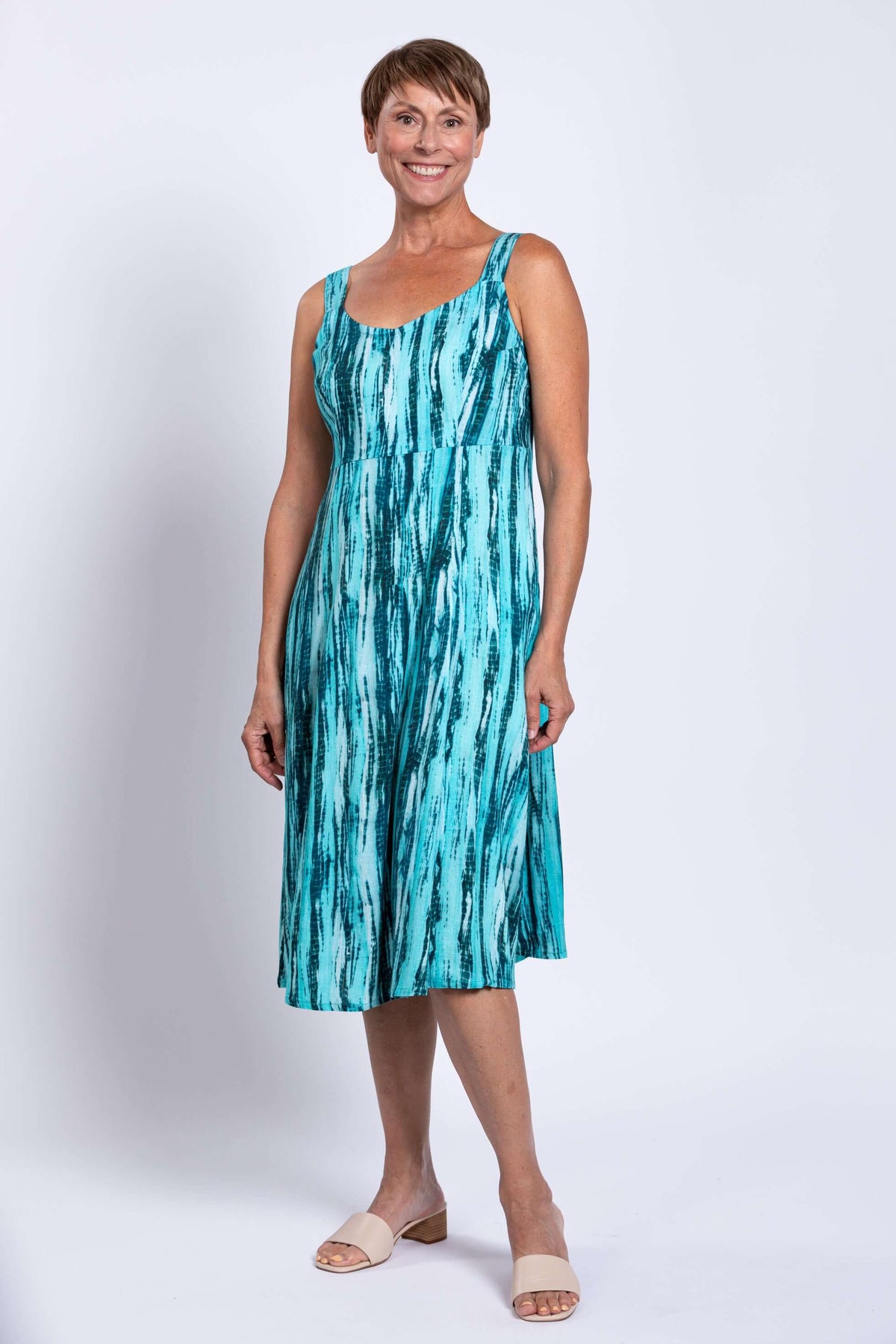 Full view of woman in teal streak A-line midi dress with pockets