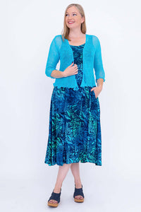 Shauna empire waist blue dress styled with cardigan, angled view