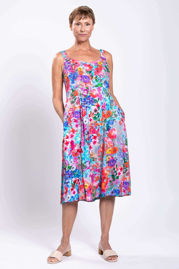 Model in floral A-line dress posing with pockets visible, front view
