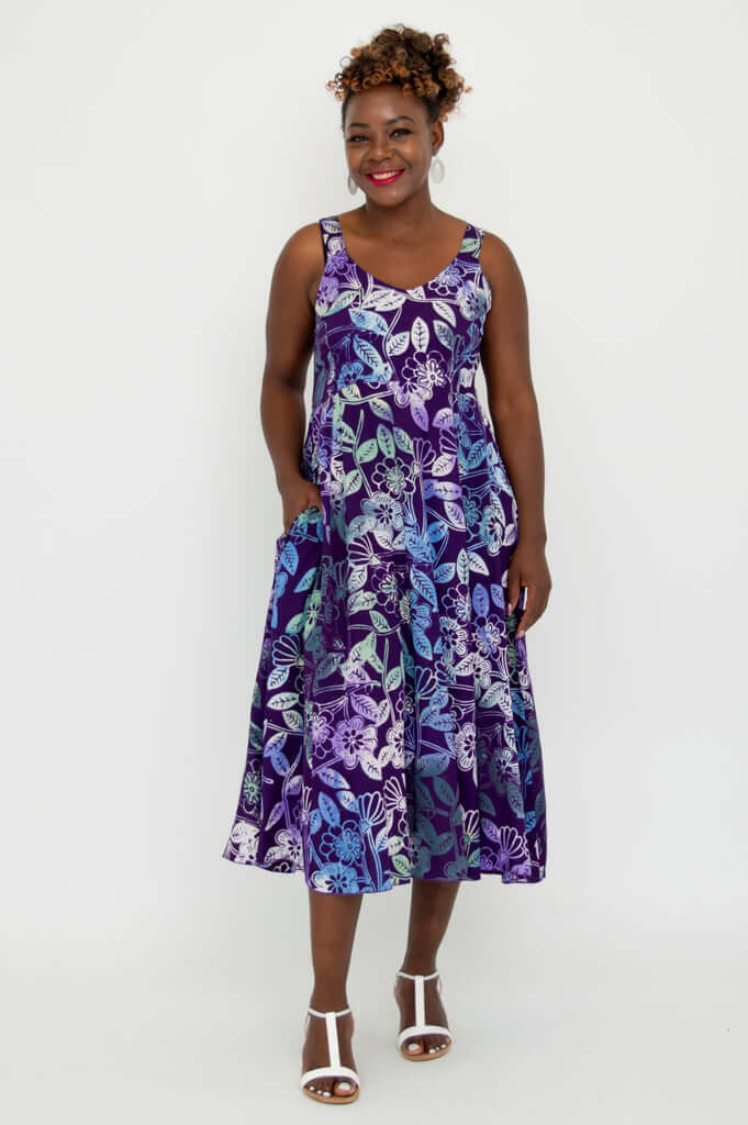 Model wearing Shauna midi dress in violet floral print with hands in pockets