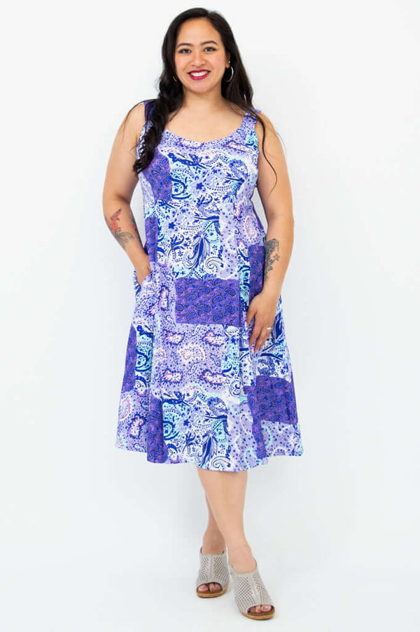 Woman showing pockets on blue patchwork Shauna midi dress