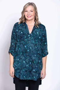 Woman wearing the Shirley blouse with blue batik pattern, front view, smiling