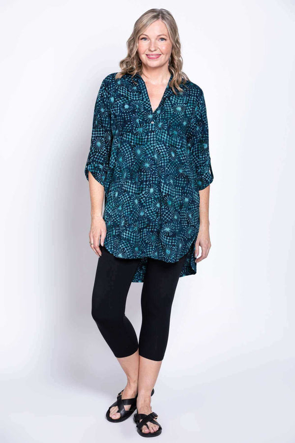 Woman in Shirley blouse and black leggings, standing, 3/4 sleeves visible