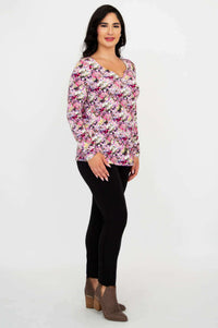 Side view of woman in floral long sleeve bamboo top and black pants