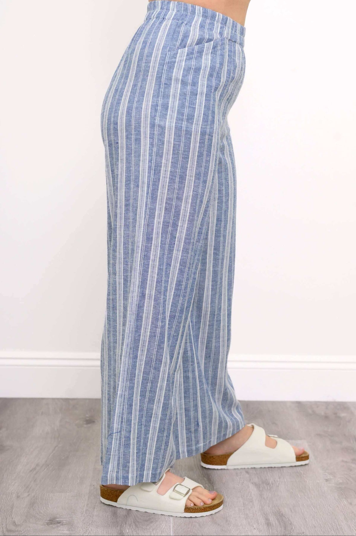 Side view of the Parker Pant showcasing the wide-leg silhouette and vertical blue stripes
