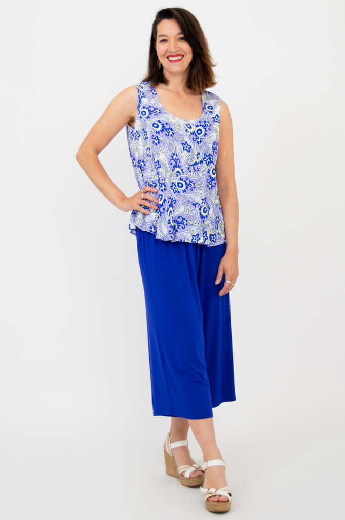 Angled side view of model in Ginny Tank and royal blue pants