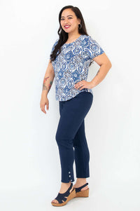 Side view of blue mosaic Tessa Tee paired with navy pants and wedge sandals