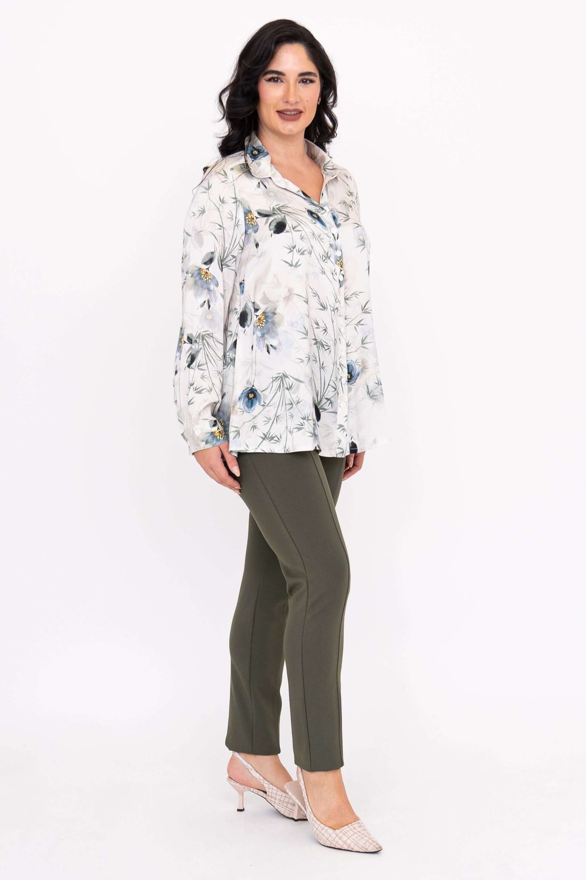 Side pose of woman in Charlotte Blouse and green pants
