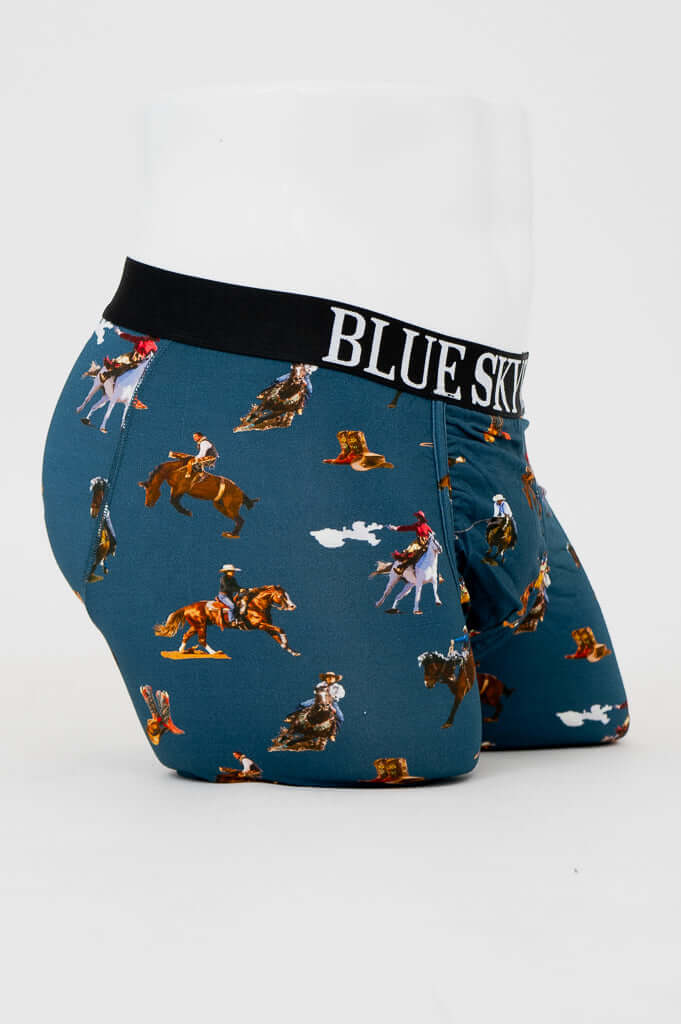 Side view of men's blue bamboo underwear featuring colorful cowboy print and black waistband