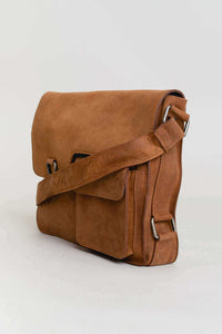 Angled side view of brown buffalo leather messenger bag showing adjustable strap