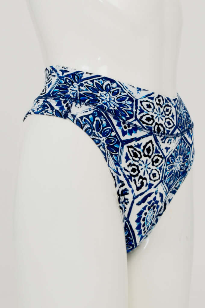 Side view of high rise thong underwear featuring blue tile-inspired print