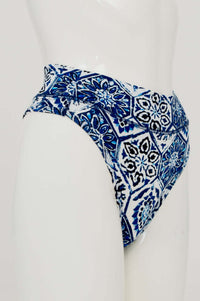 Side view of high rise thong underwear featuring blue tile-inspired print
