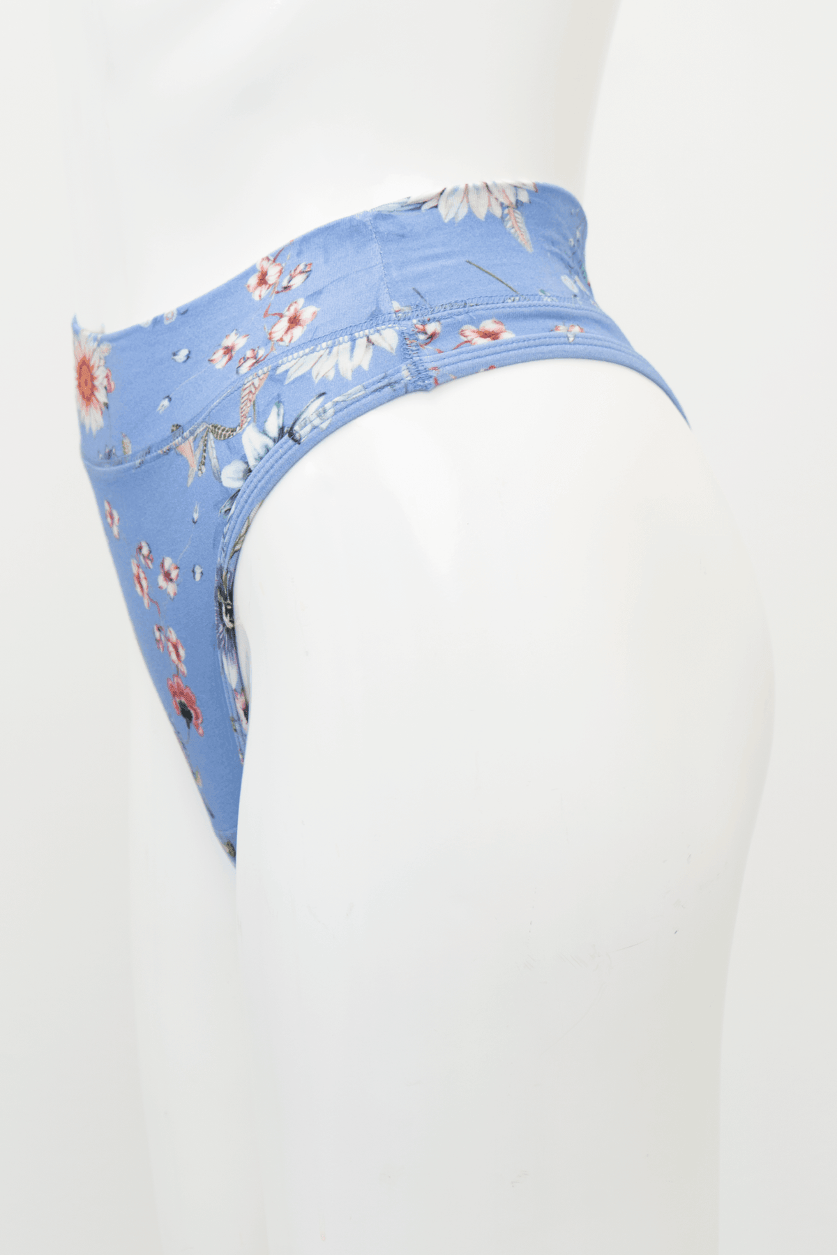 Side view of a blue floral high rise bamboo thong on mannequin