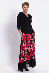 Side pose of model highlighting pockets on Vera floral maxi skirt