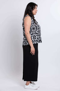Side profile of model wearing sleeveless Ikat print tank and long black skirt