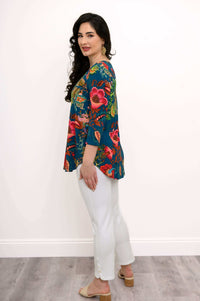 Side profile of woman in Jackie V Neck teal floral bamboo top and white pants
