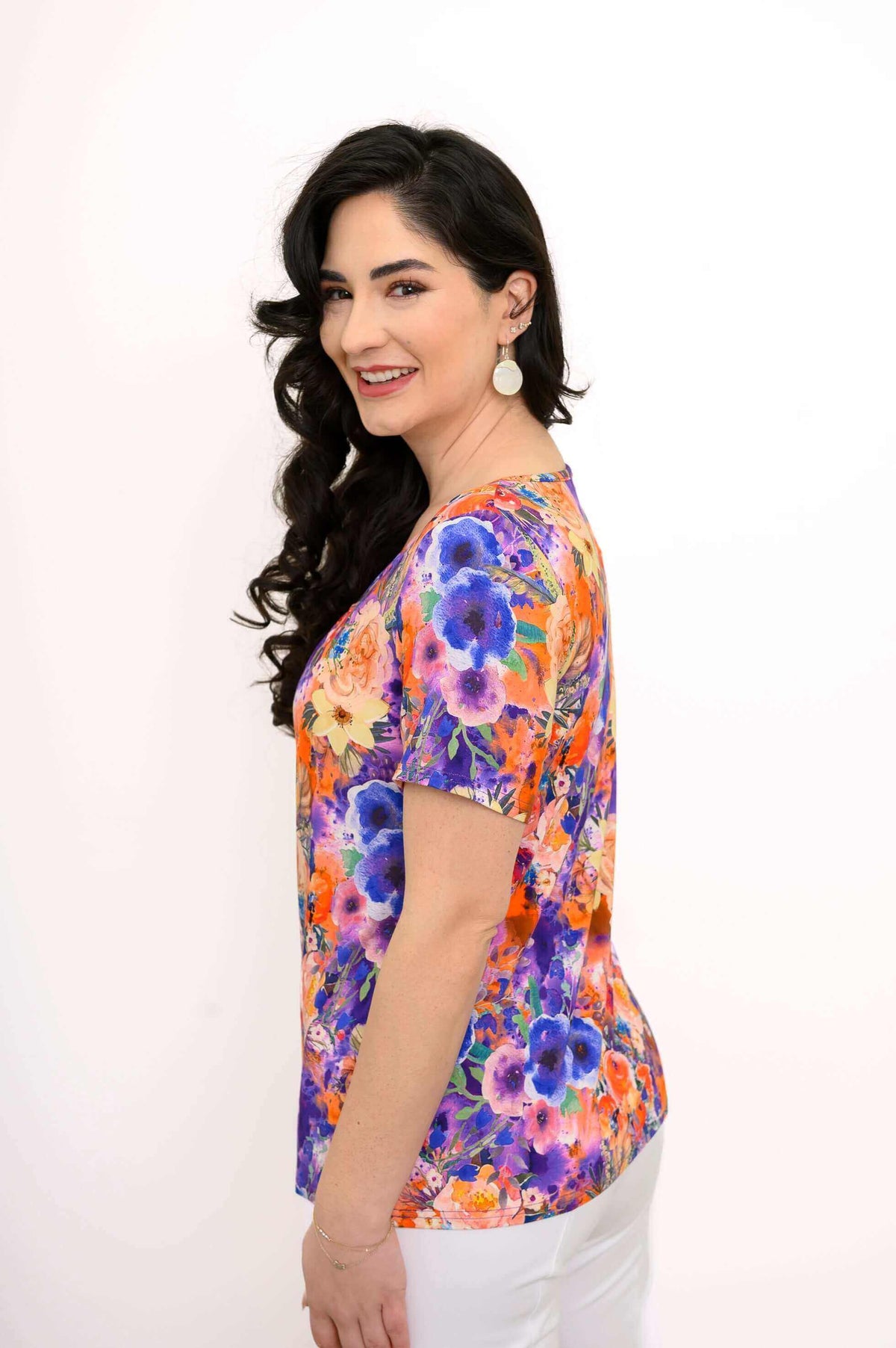 Side profile of woman in vivid floral bamboo top