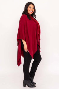 Side view of woman in red faux fur wrap and black heeled boots