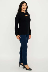 Side profile of model in black sweater with neck cutout and navy pants