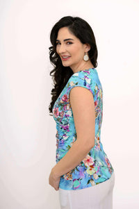 Angled side view of model in blue floral cap sleeve tank top