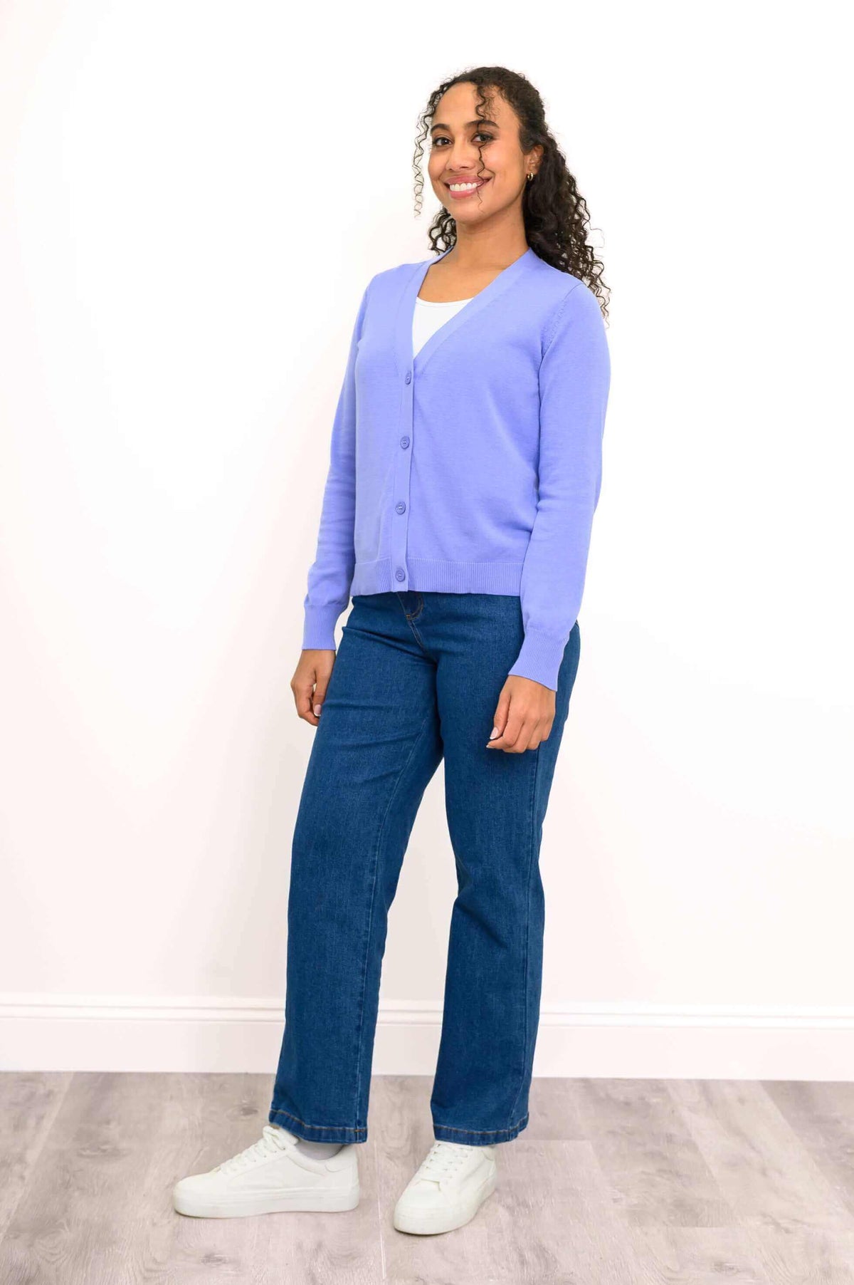 Side view of model in a light purple cardigan, smiling