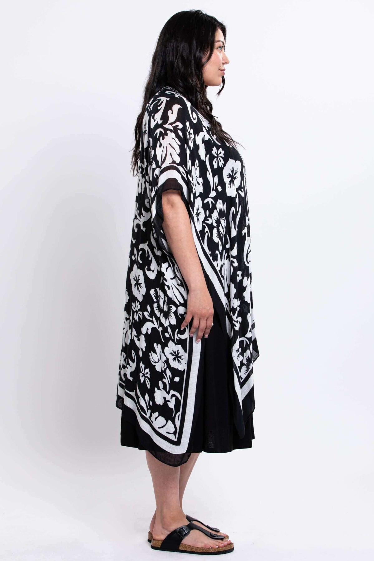 Side profile of model showcasing black floral kimono wrap