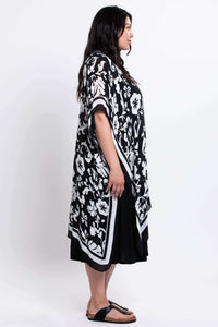 Side profile of model showcasing black floral kimono wrap