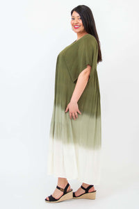 Side profile of a woman in an olive ombre tiered maxi dress with V-neckline