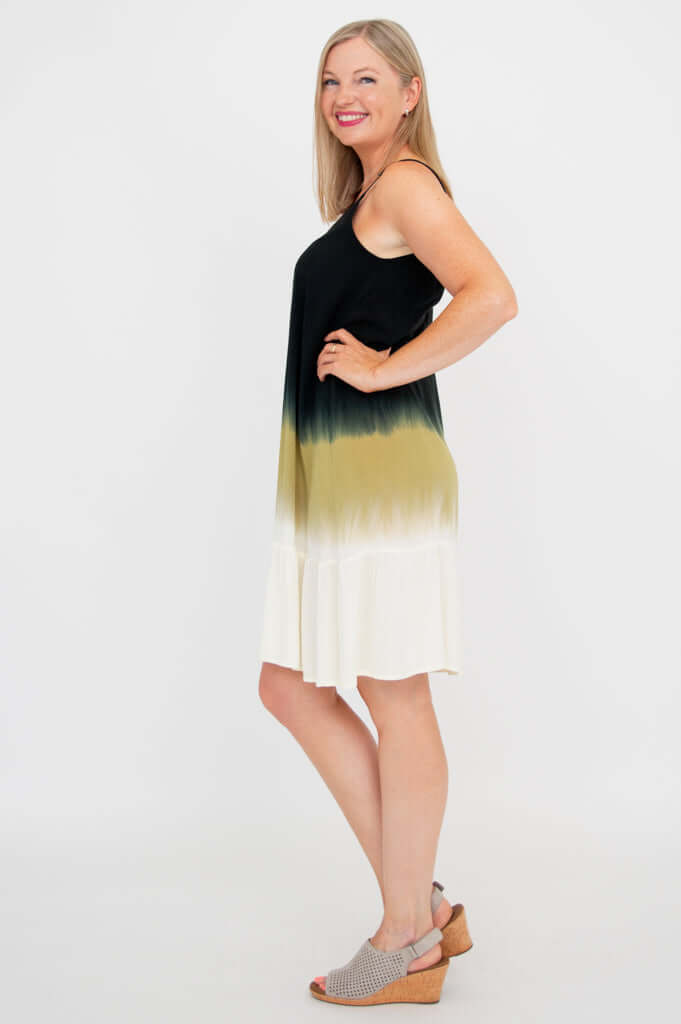 Side profile of woman in sleeveless tiered dress with adjustable straps