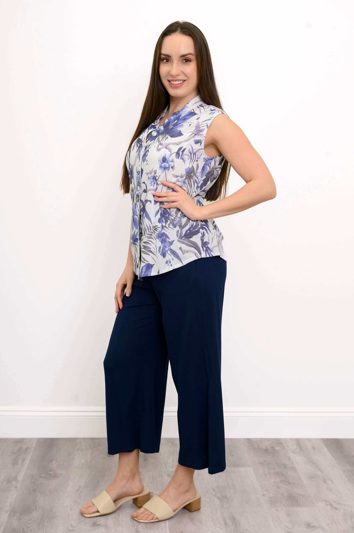 Side view of woman wearing blue floral blouse with mandarin collar