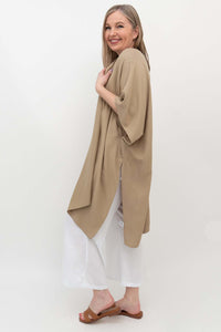 Side view of model in sand kimono wrap showing sleeve and drape