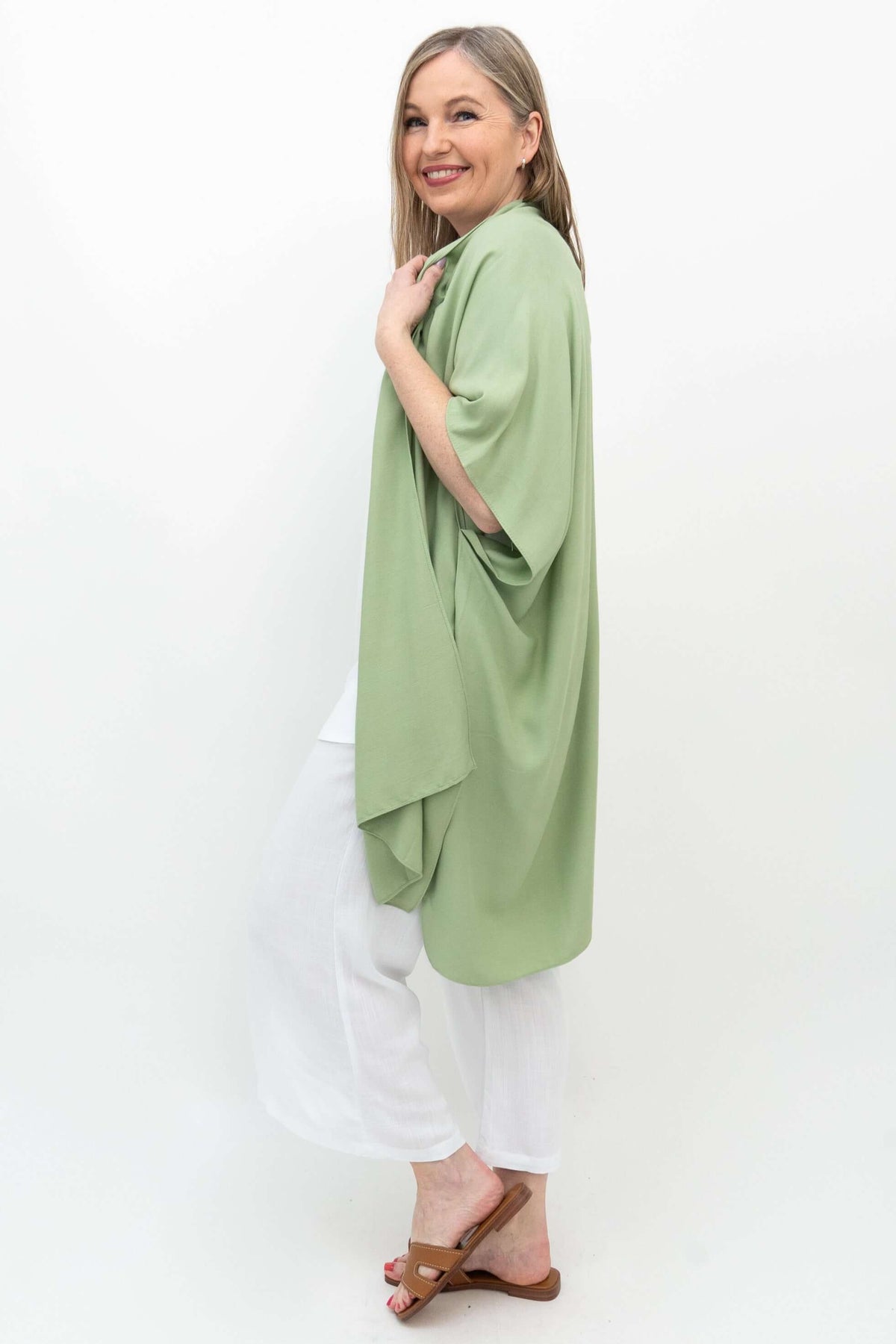 Side view of woman showcasing the flowy sage green kimono wrap