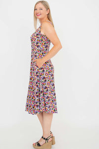 Side view of woman in floral tank dress showing pocket detail