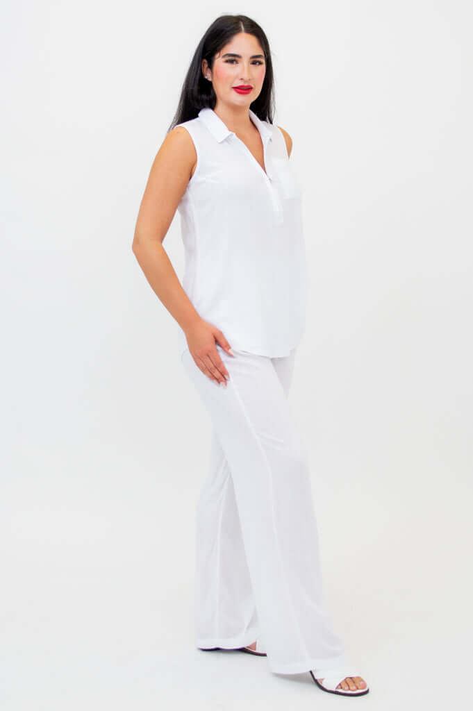 Side view of woman in white quarter-zip tank and wide-leg pants
