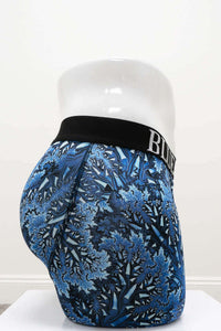 Side view of Middle Man Boxer Briefs with black waistband and blue leaf print on mannequin