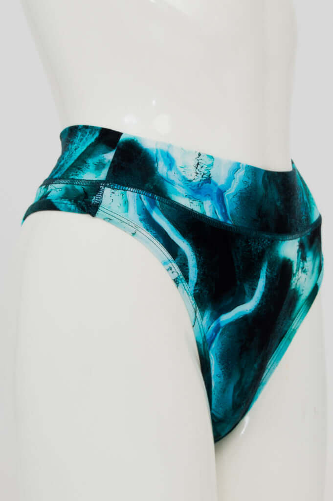 Side view of blue marble high rise thong on mannequin