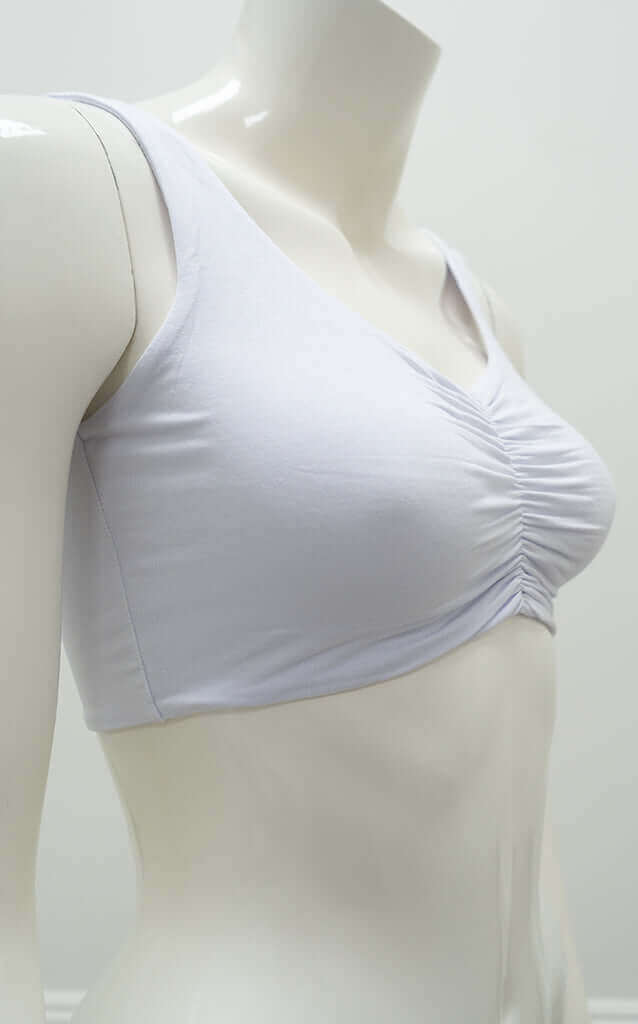 Side angle of the Clipper Top in white showing wide straps and ruched front