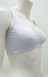 Side angle of the Clipper Top in white showing wide straps and ruched front