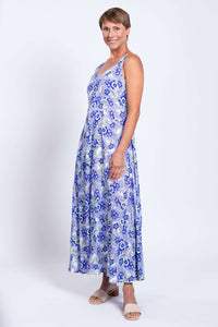 Side view of a woman modeling a blue paisley sleeveless maxi dress