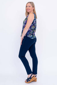 Side view of woman wearing vibrant Dee Tank leaf print sleeveless top