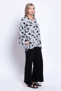 Side profile of woman in black and white floral top with relaxed fit
