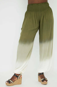 Side angle of ombre pants showing gathered waist and draped leg, model standing in sandals