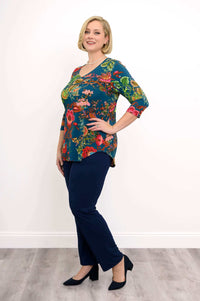 Side view of woman in Jackie V Neck teal bamboo top with colorful floral pattern