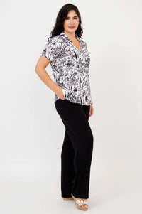 Side view of woman wearing Samantha black and white print shirt with hand in pocket