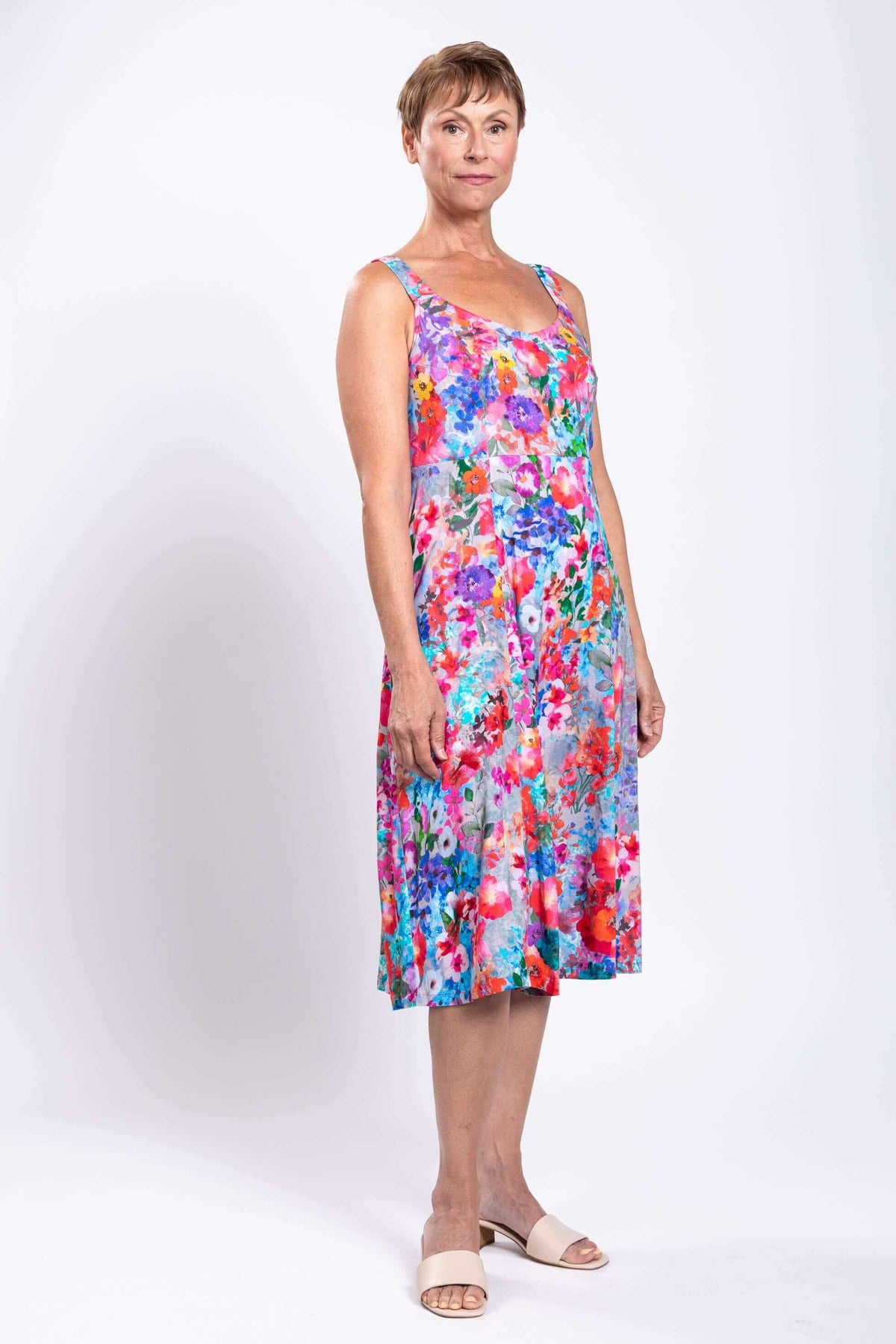 Side angle of model in colorful floral A-line dress, showing fit and shape