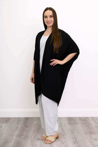 Side angle of woman modeling black Darcy kimono wrap and white pants