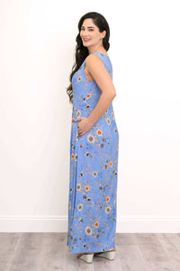 Side view of woman wearing a blue floral shift maxi dress with pockets